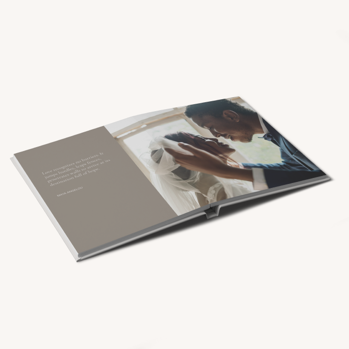 Layflat photo book with a full-bleed image spanning both pages of a couple on their wedding day, with text on the left hand side.